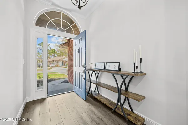 a view of front door with wooden floor