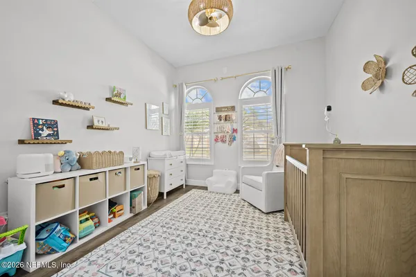 a room with furniture a baby crib and a window