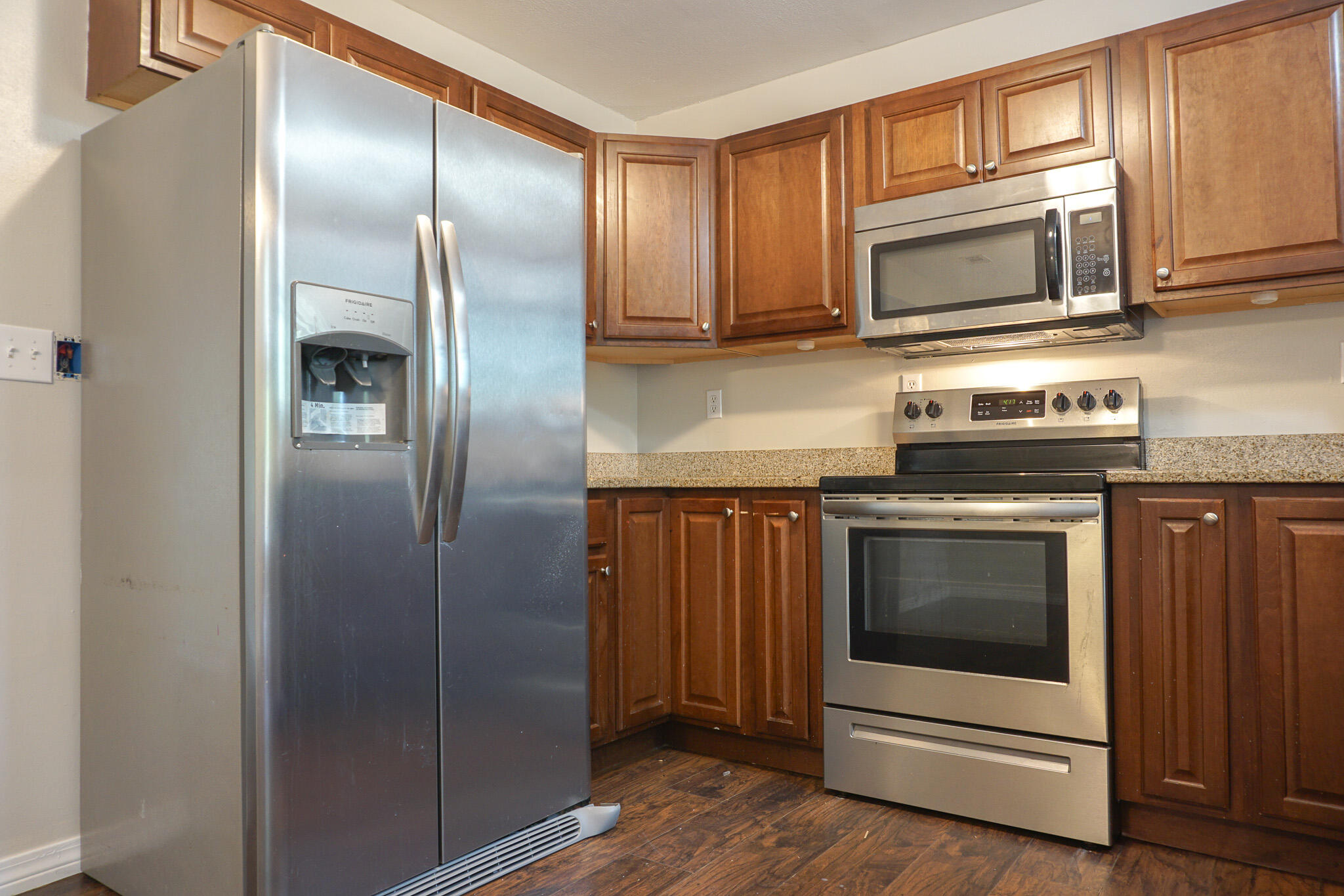 6115 Willow Lane North Crestview, FL 32539 - Photo 18 of 29 a kitchen with granite countertop stainless steel appliances a stove a microwave and a refrigerator