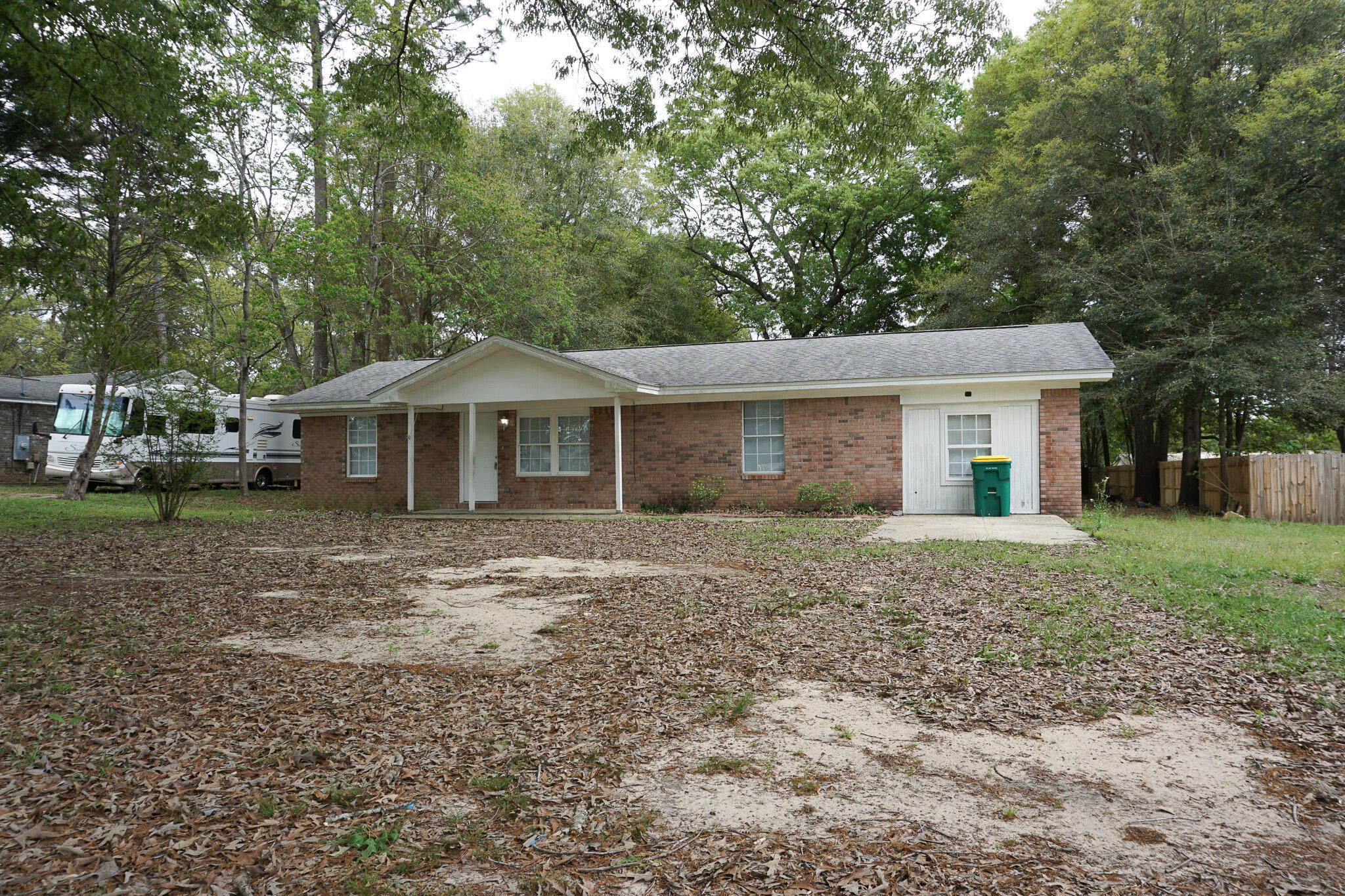6115 Willow Lane North Crestview, FL 32539 - Photo 2 of 29 a front view of a house with a garden
