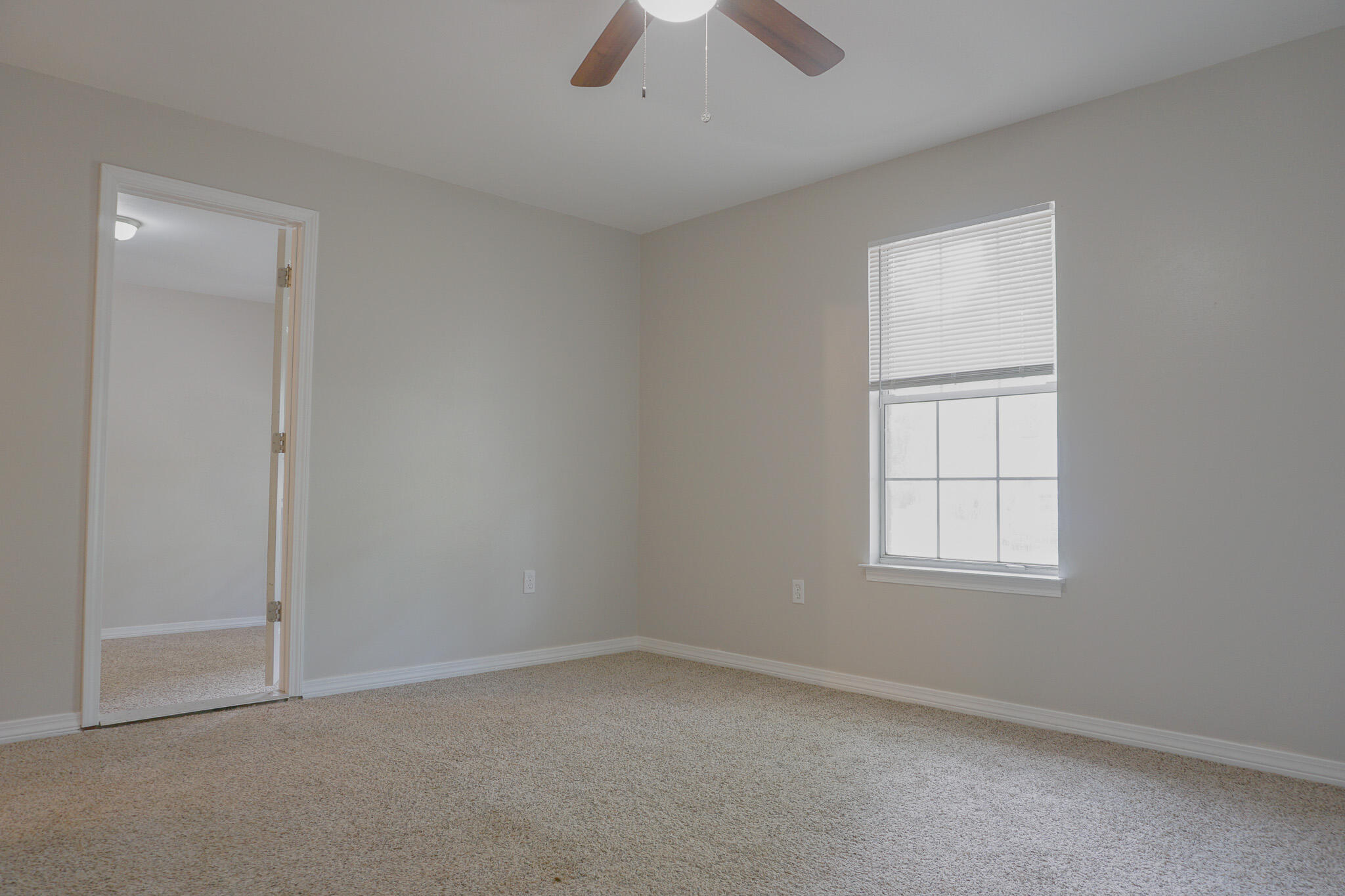 6115 Willow Lane North Crestview, FL 32539 - Photo 10 of 29 an empty room with chandelier fan and window