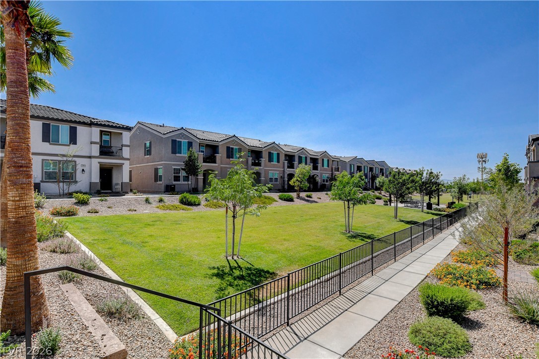 484 Filaree Place Henderson, NV 89015 - Photo 62 of 71 This residential complex features modern townhomes with lush green spaces and scenic walkways.