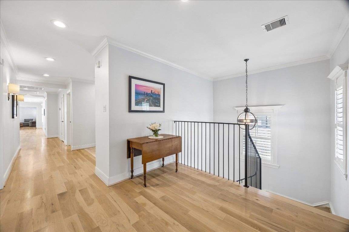 1741 Banks Street Houston, TX 77098 - Photo 11 of 31 a view of a hallway with wooden floor and a bathroom