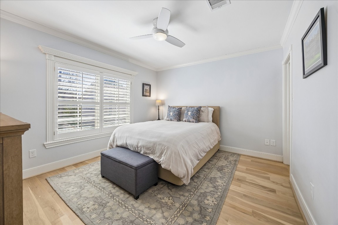 1741 Banks Street Houston, TX 77098 - Photo 15 of 31 a spacious bedroom with a bed and wooden floor
