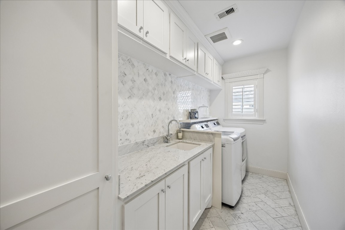 1741 Banks Street Houston, TX 77098 - Photo 25 of 31 a view of a bathroom with a sink and a mirror