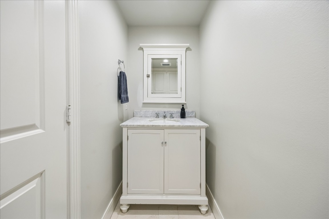 1741 Banks Street Houston, TX 77098 - Photo 29 of 31 a bathroom with a sink and a mirror