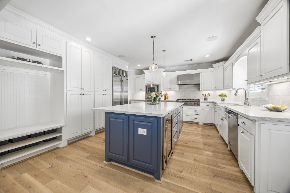 1741 Banks Street Houston, TX 77098 - Photo 7 of 31 a large kitchen with stainless steel appliances kitchen island granite countertop a large counter top a sink and a refrigerator