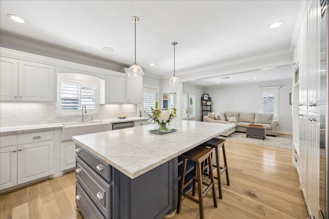 1741 Banks Street Houston, TX 77098 - Photo 8 of 31 a kitchen with a stove a counter space and a center island