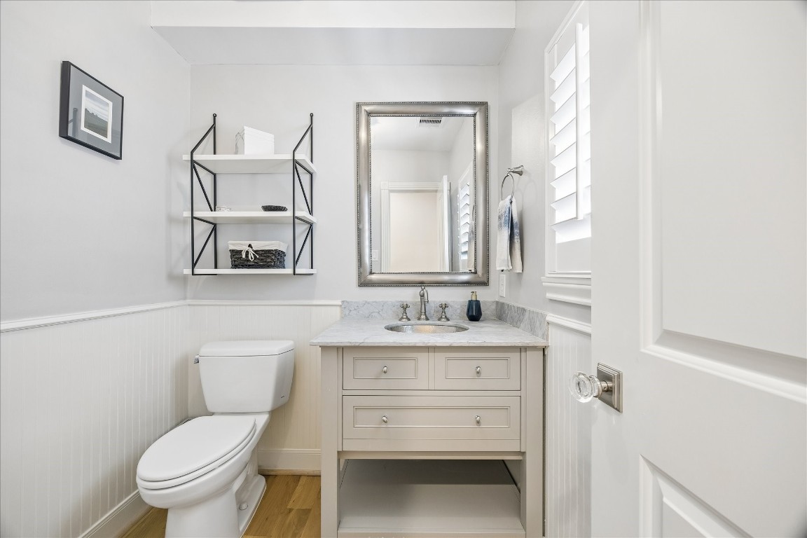 1741 Banks Street Houston, TX 77098 - Photo 10 of 31 a bathroom with a toilet sink vanity and mirror