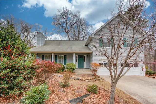 a front view of a house with a garden