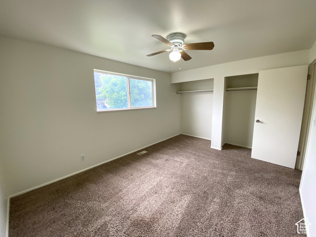 2989 Rae Street West Valley City, UT 84120 - Photo 13 of 25 Carpeted room featuring a ceiling fan with integrated lighting, a double window, and two closet openings