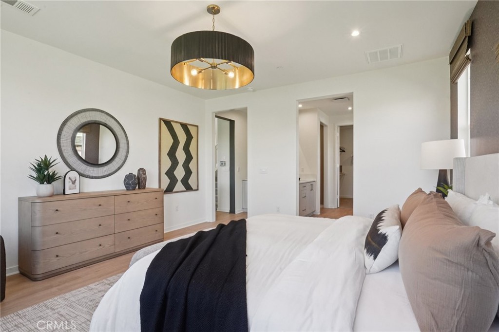 73525 Raphael Drive Palm Desert, CA 92211 - Photo 38 of 41 a bedroom with a bed and a chandelier