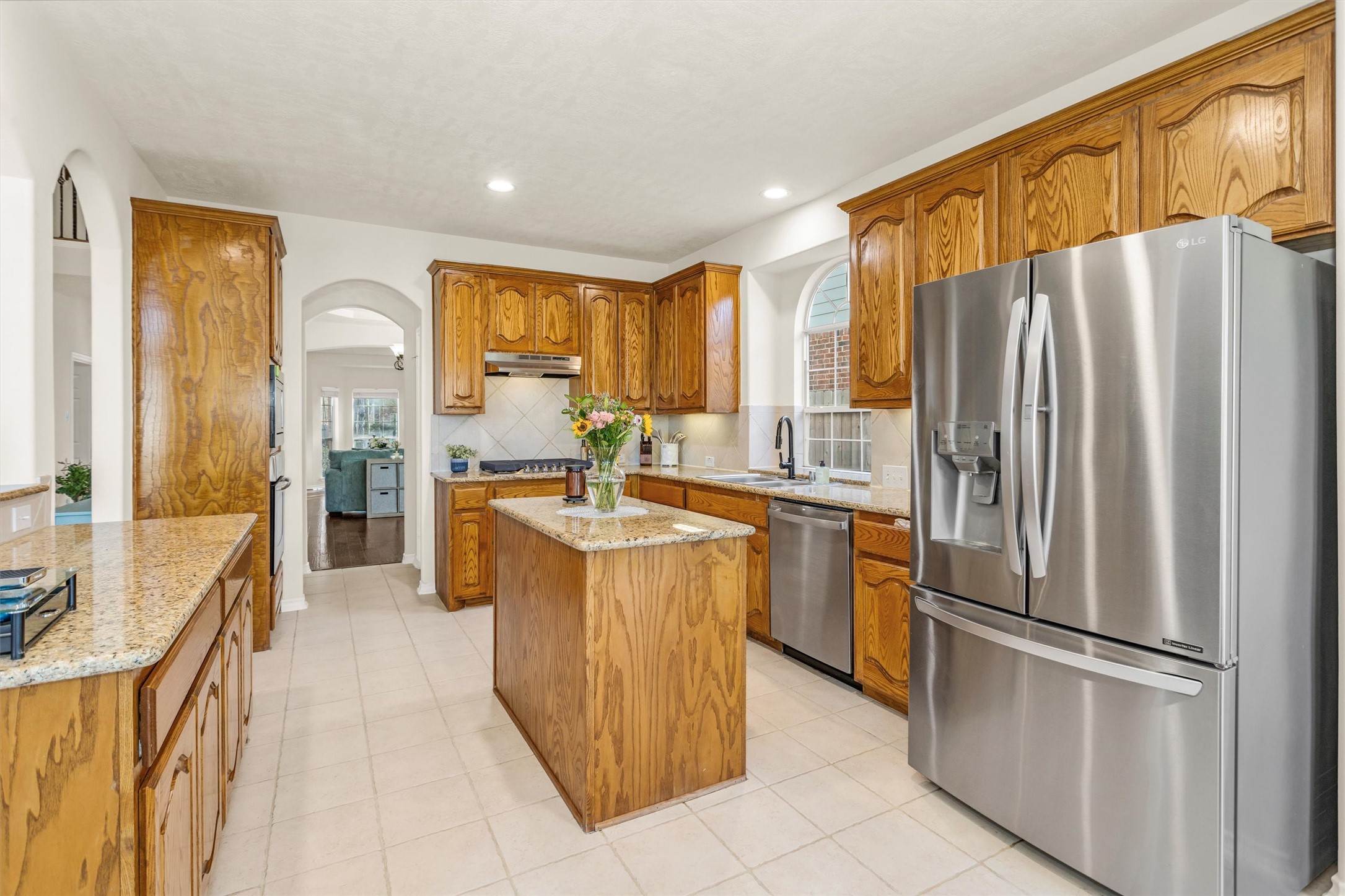 3211 Burton Ridge Drive Spring, TX 77386 - Photo 16 of 49 a kitchen with a refrigerator a sink and cabinets