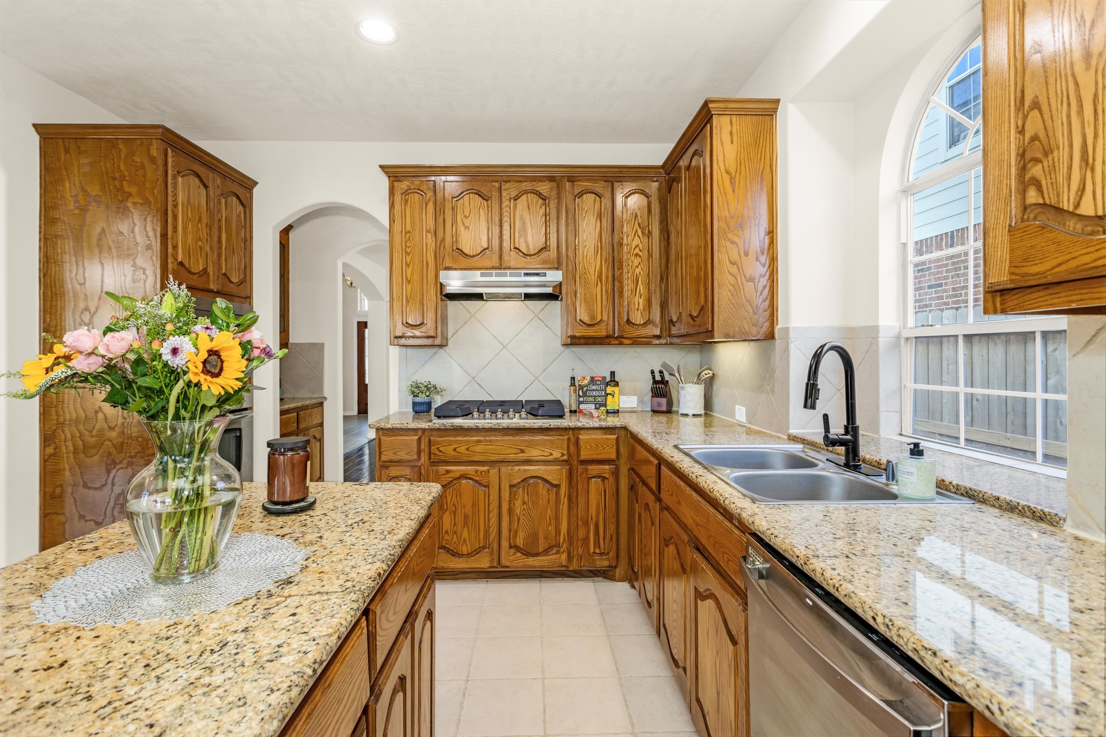 3211 Burton Ridge Drive Spring, TX 77386 - Photo 18 of 49 a kitchen with granite countertop a sink stove and cabinets