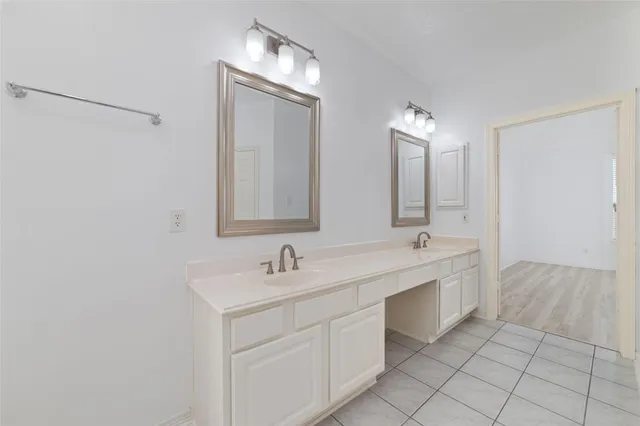 a bathroom with a double vanity sink mirror and