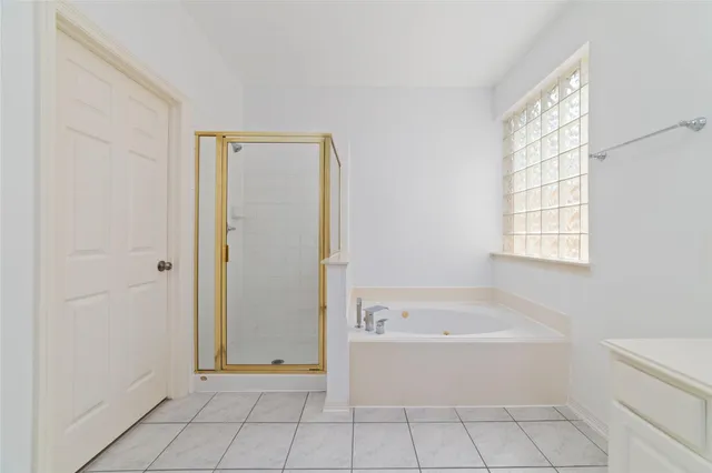 a bathroom with a bathtub and shower