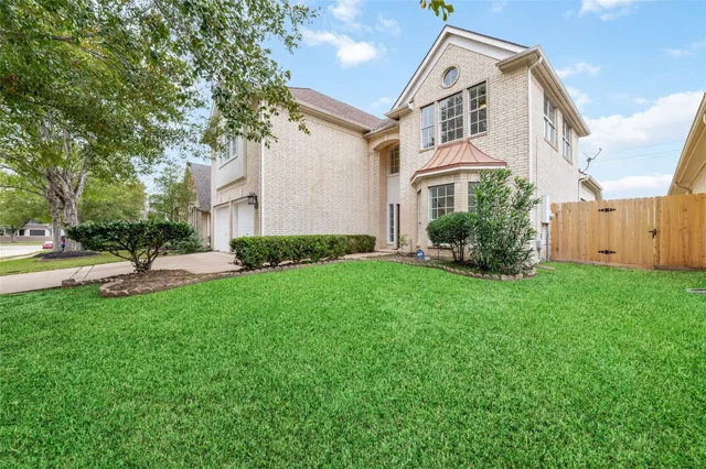 a front view of house with yard and green space