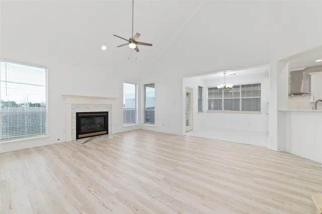 a view of empty room with wooden floor and fireplace