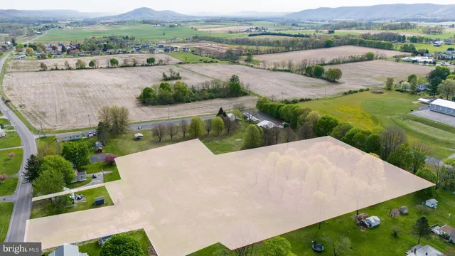 an aerial view of a house with yard and green space