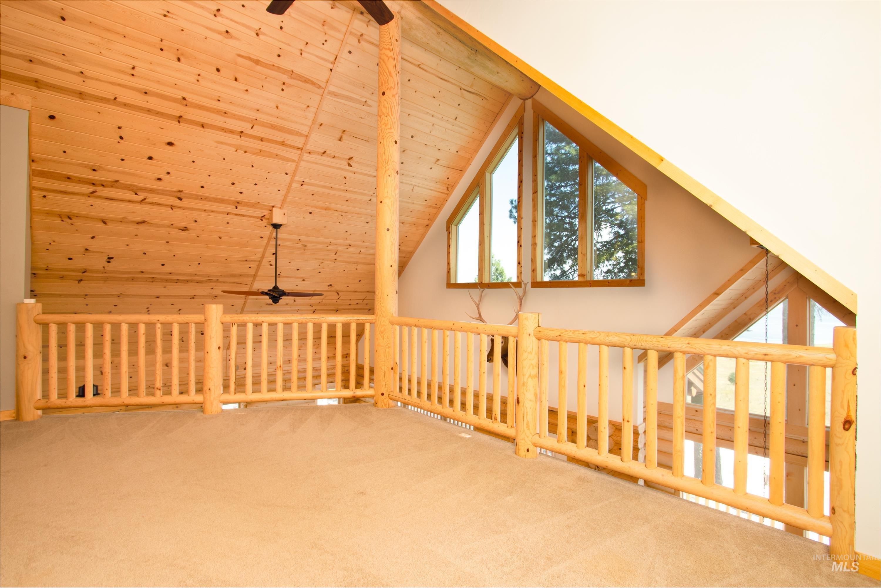 1539 West Mountain Road Cascade, ID 83611 - Photo 16 of 33 Additional living space with ceiling fan, carpet, and a vaulted wood ceiling