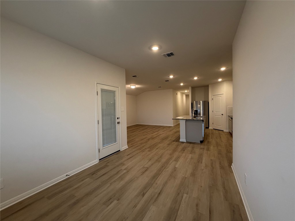 100 Honey Bee Road Jarrell, TX 76537 - Photo 5 of 17 Unfurnished living room with recessed lighting and light wood-style floors