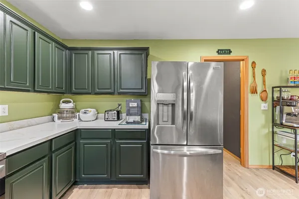 a kitchen with stainless steel appliances granite countertop a refrigerator and a sink