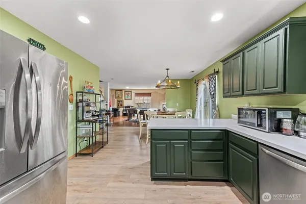 a kitchen with lots of counter top space and stainless steel appliances