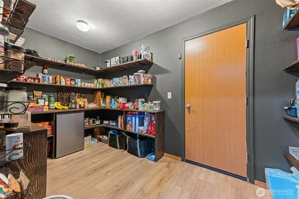 a room with lots of books and a large window