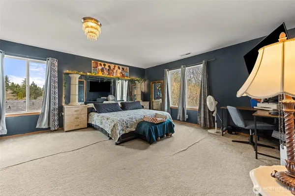 a spacious bedroom with a bed and a table