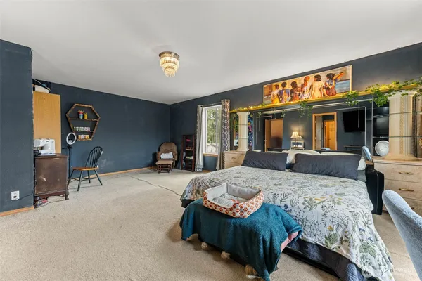 a bedroom with a bed a table and chair
