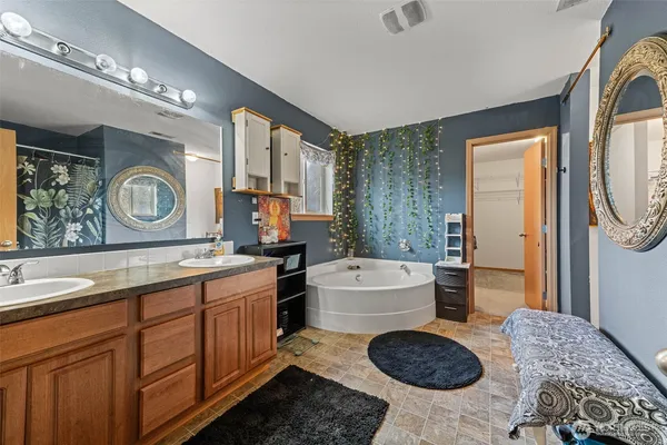 a room with a couch a washer and dryer