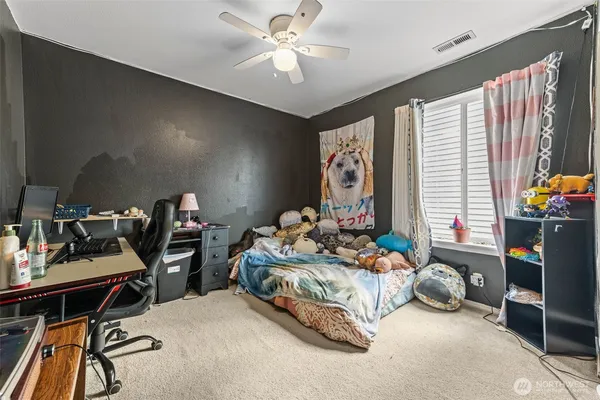 a bedroom with bed and a window