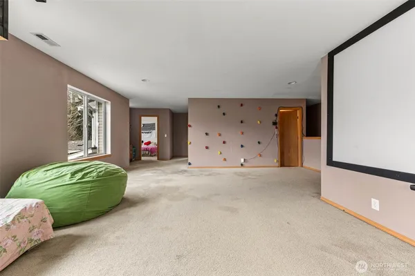 a living room with a bed and a dresser