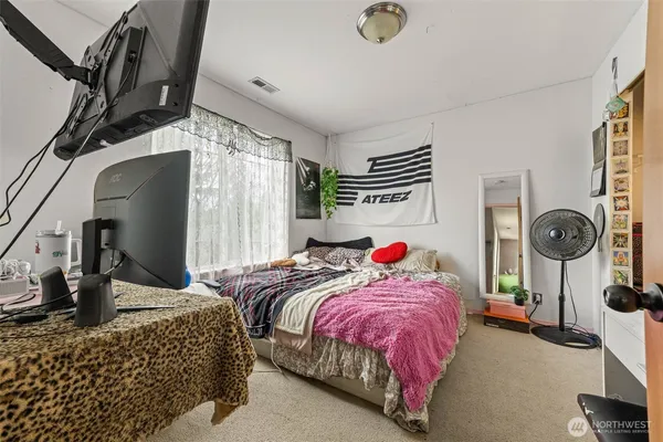 a bedroom with bed and cabinets
