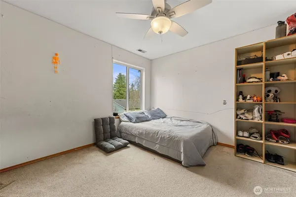 a bedroom with a bed and a book shelf