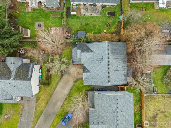an aerial view of residential house with outdoor space and parking