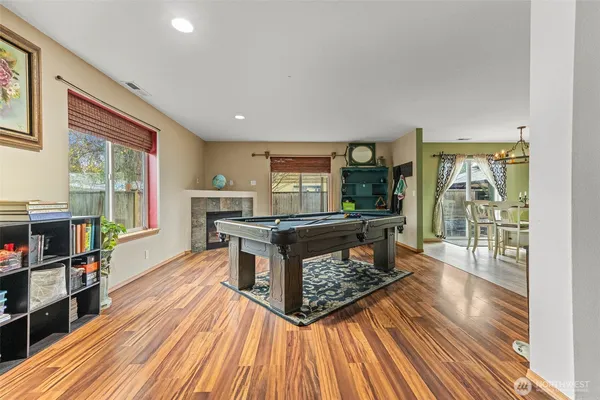 a living room with furniture and a wooden floor