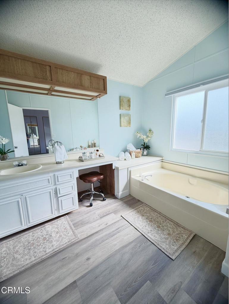 75 Copland Circle, Unit 75 Ventura, CA 93003 - Photo 13 of 22 a bathroom with a sink a vanity and a bathtub