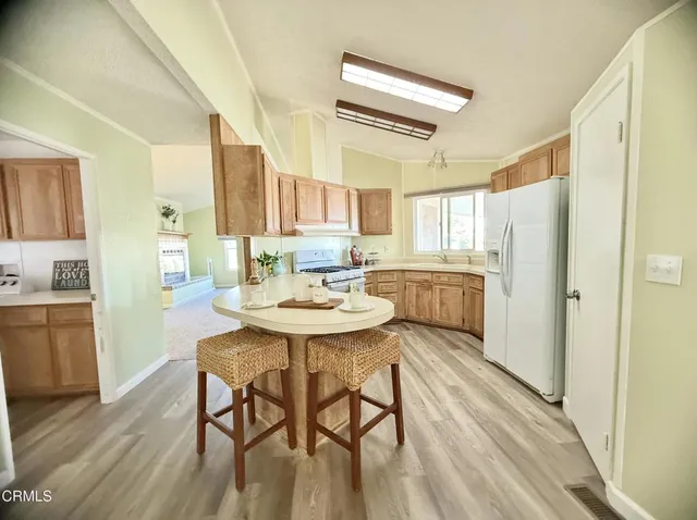 a kitchen with dining table and wooden floors