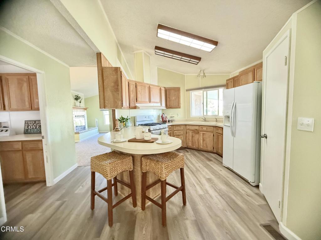 75 Copland Circle, Unit 75 Ventura, CA 93003 - Photo 4 of 22 a kitchen with dining table and wooden floors