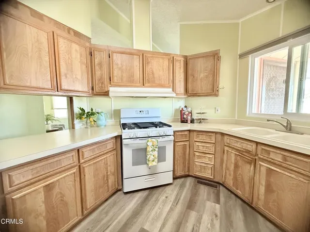 a kitchen with a sink window and cabinets