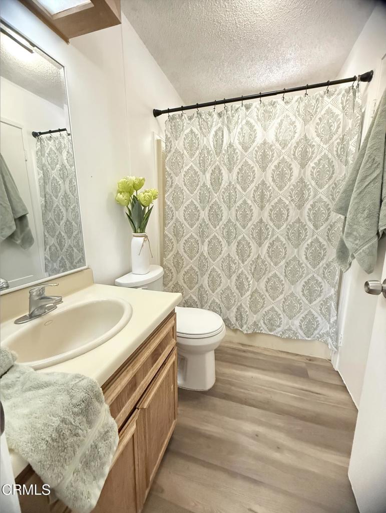 75 Copland Circle, Unit 75 Ventura, CA 93003 - Photo 10 of 22 a bathroom with a granite countertop sink and a mirror
