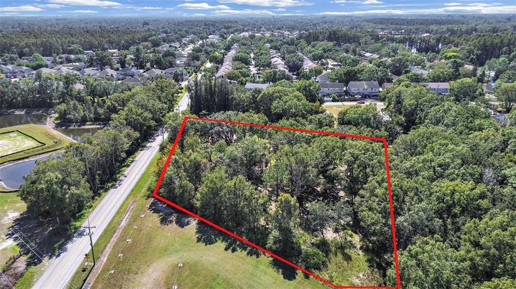 an aerial view of house with yard and mountain view in back