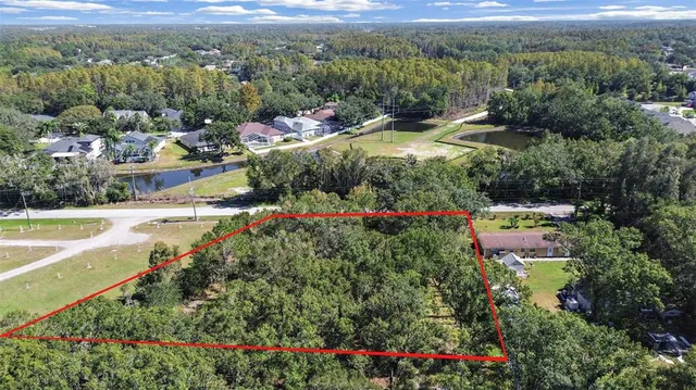 an aerial view of residential houses with outdoor space and swimming pool