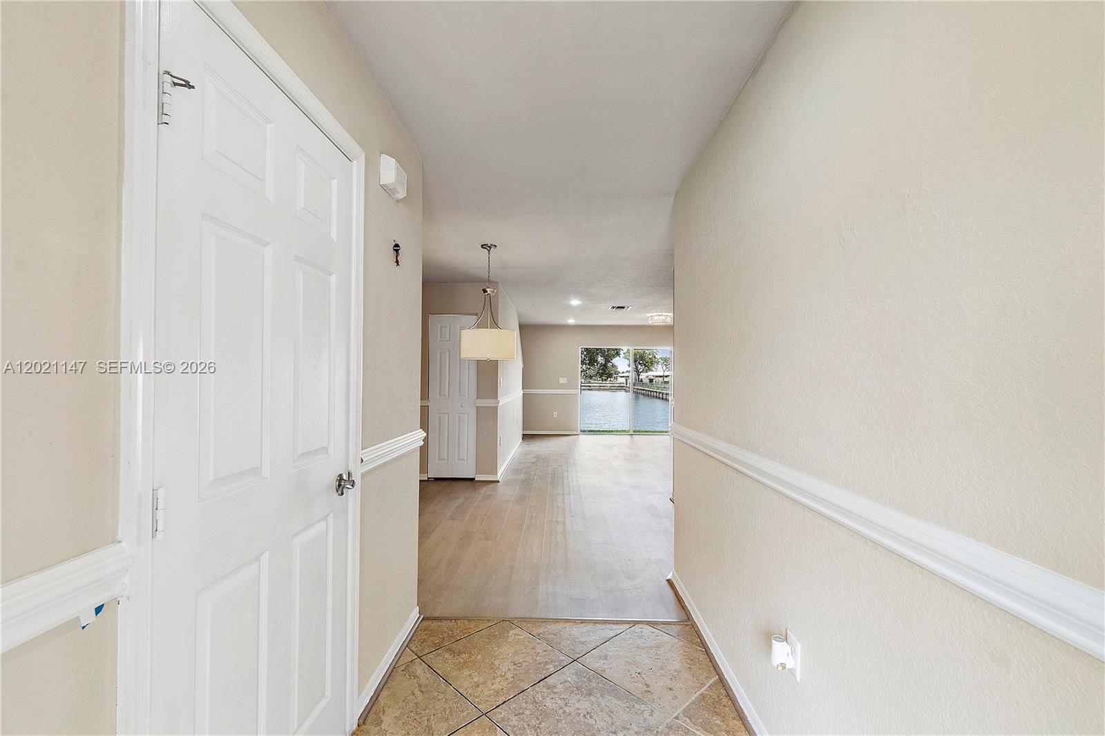 5930 Abbey Road Tamarac, FL 33321 - Photo 8 of 26 a view of a hallway with a kitchen