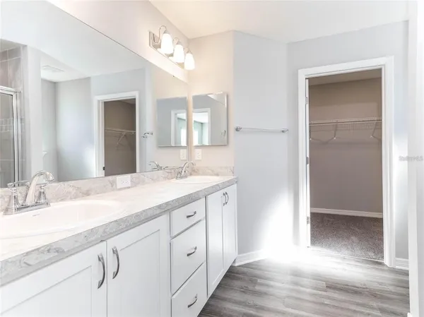 a spacious bathroom with a granite countertop sink and a mirror