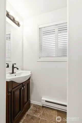 a bathroom with a sink and a window