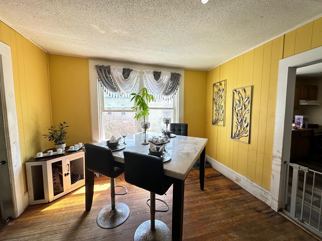 391 Pleasant Street Holyoke, MA 01040 - Photo 3 of 14 a view of a dining room with furniture window and wooden floor