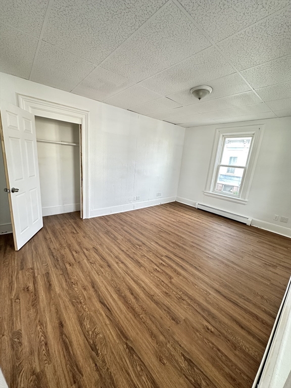 391 Pleasant Street Holyoke, MA 01040 - Photo 4 of 14 an empty room with wooden floor and windows