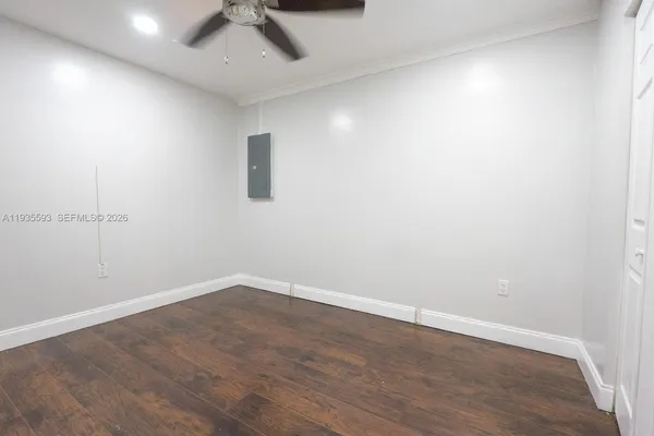 an empty room with a ceiling fan and carpet